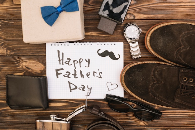 Free photo happy fathers day title on paper near male shoes and accessories