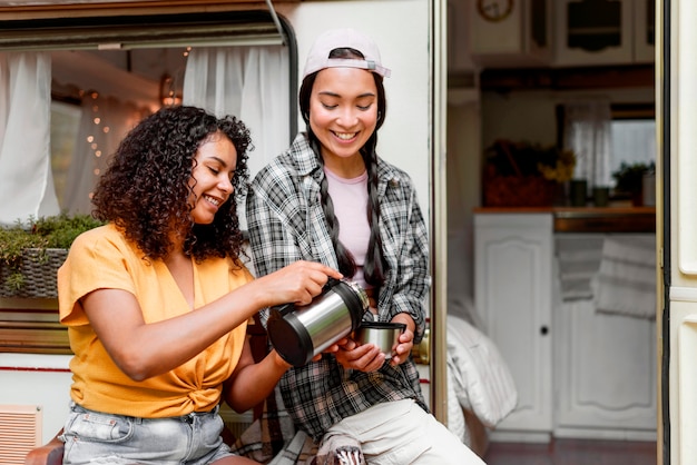 Happy female friends drinking coffee together