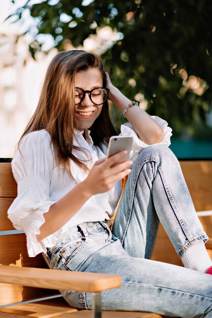 Happy female student with long light-brown hair in spectaculars