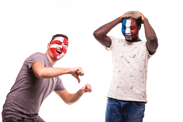 Free photo happy football fan of croatia celebrate win over upset football fan of france with painted face isolated on white background