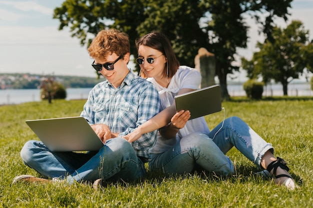 Happy freelancers working in the park