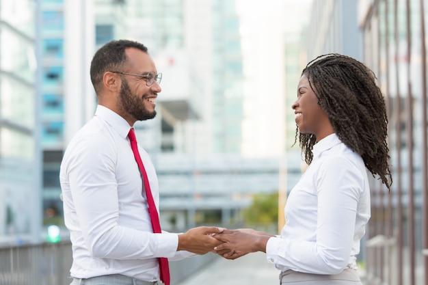 Happy friendly diverse colleagues sharing good news