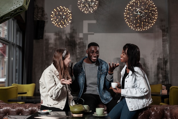 Free photo happy friends laughing in cafe