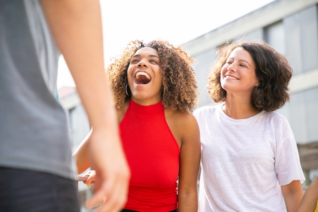 Free photo happy friends laughing on street