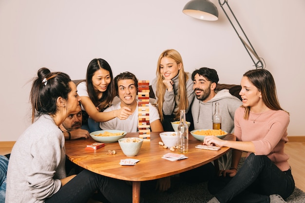 Happy friends playing tabletop game