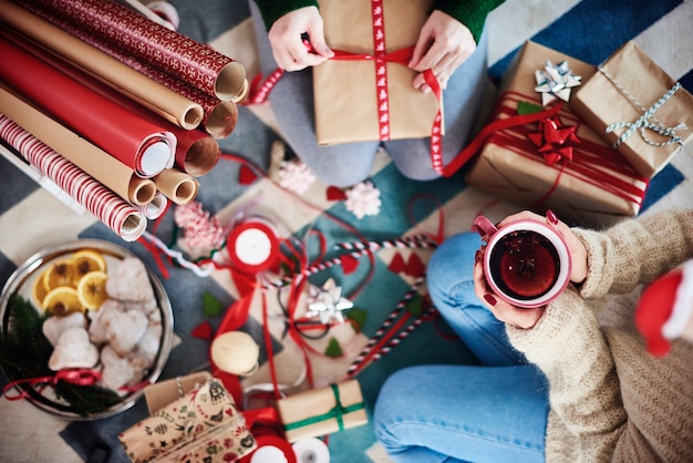 Happy friends preparing christmas presents for Christmas