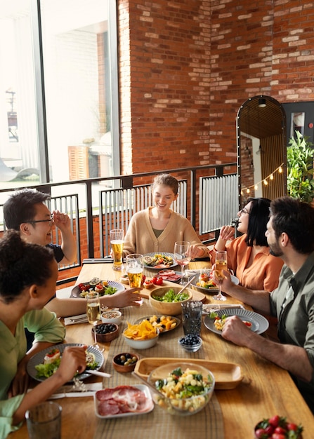 Happy friends sitting at table