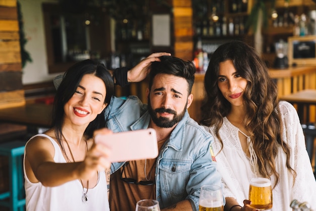 Happy friends taking a selfie