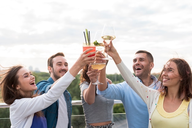 Free photo happy friends toasting at a party