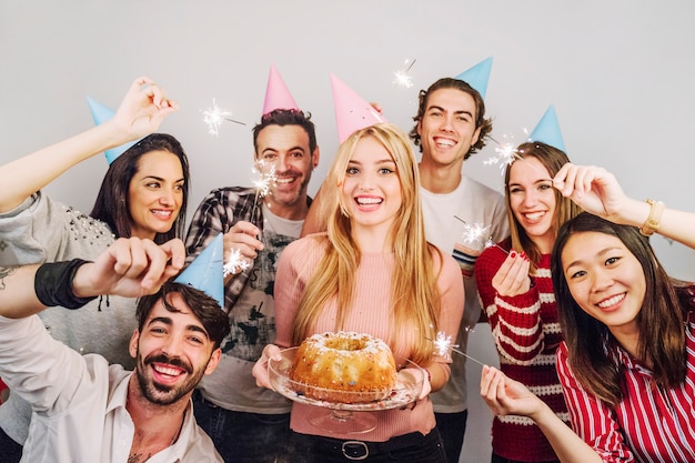 Free photo happy friends with birthday cake