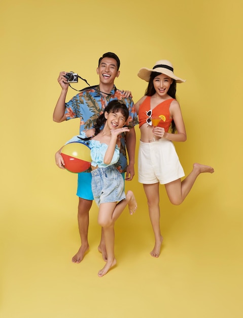 Happy fun asian family vacation portrait Father mother and daughters enjoying summer beach