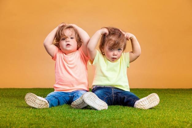 Free photo happy funny girl twins sisters playing and laughing