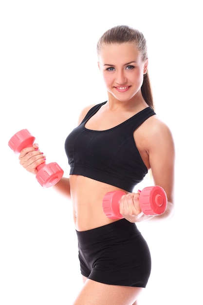 Happy girl doing exercises with dumbbells