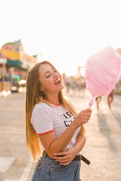 Happy girl eating cotton candy