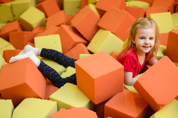 Free photo happy girl enjoying soft blocks playground