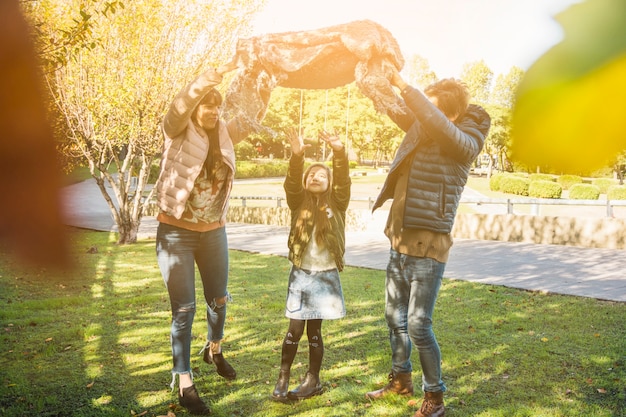 Free Photo happy girl enjoying weekend with her parents in park