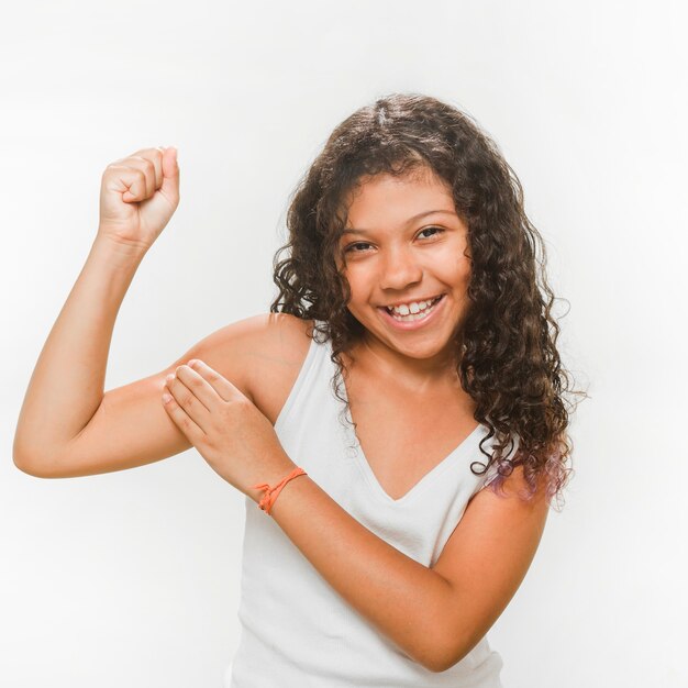 Happy girl flexing her muscles