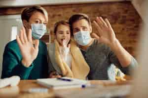 Free photo happy girl and her parents having video call from home during coronavirus pandemic