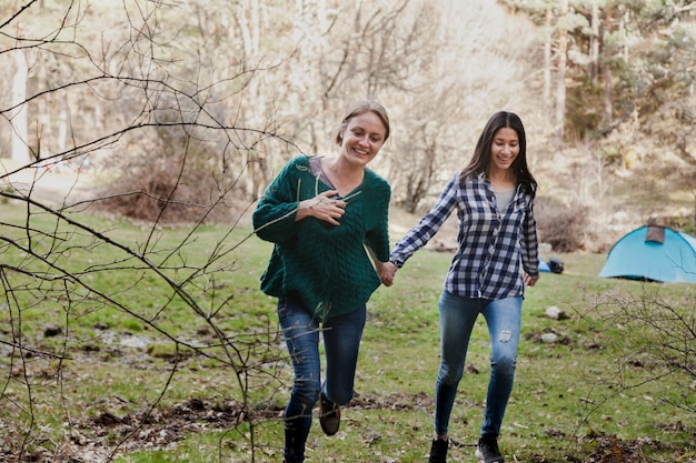 Happy girl holding her friend's hand