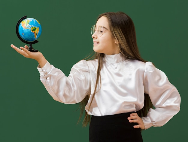 Happy girl looking at globe