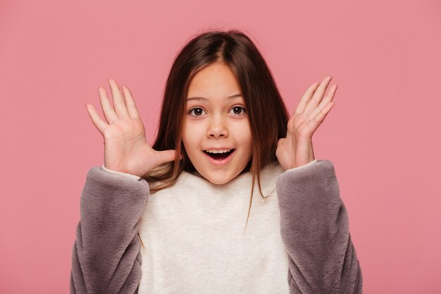 Happy girl looking with raised hands isolated