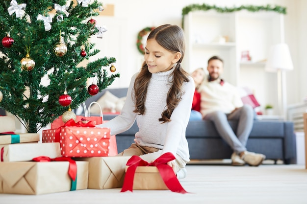 Happy girl opening Christmas presents