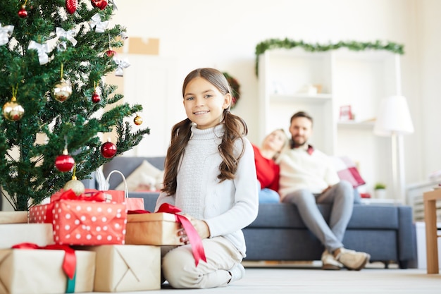 Happy girl opening Christmas presents