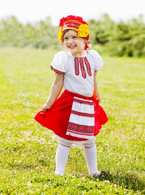 Happy girl in russian traditional folk clothes