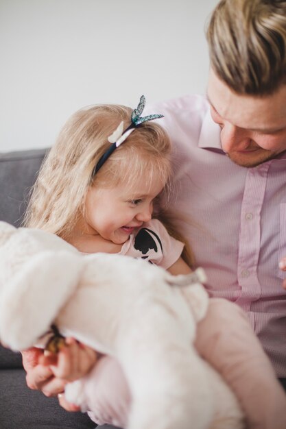 Happy girl sitting with her father