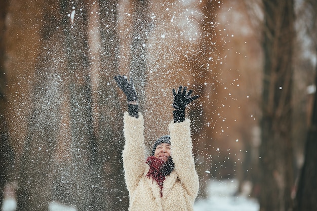 Happy girl throwing snow