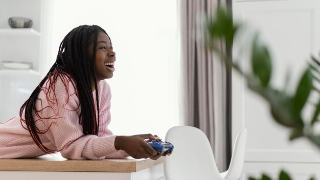 Happy girl with controller medium shot