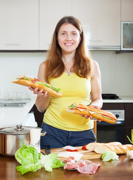 Happy girl with cooked sandwiches