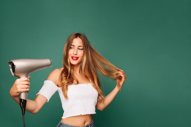 Happy girl with hairdryer