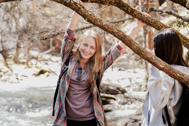 Free photo happy girl with hands on a branch