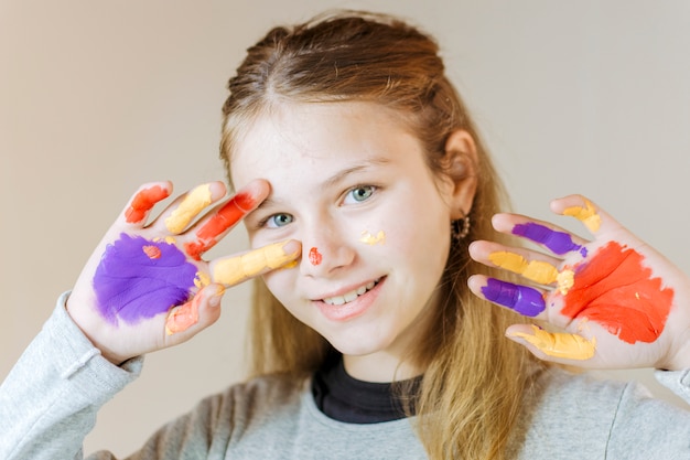 Free Photo happy girl with hands painted in watercolor paint