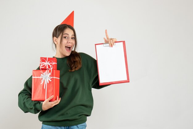 happy girl with red party cap standing on white