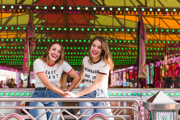 Free photo happy girls having fun in the amusement park