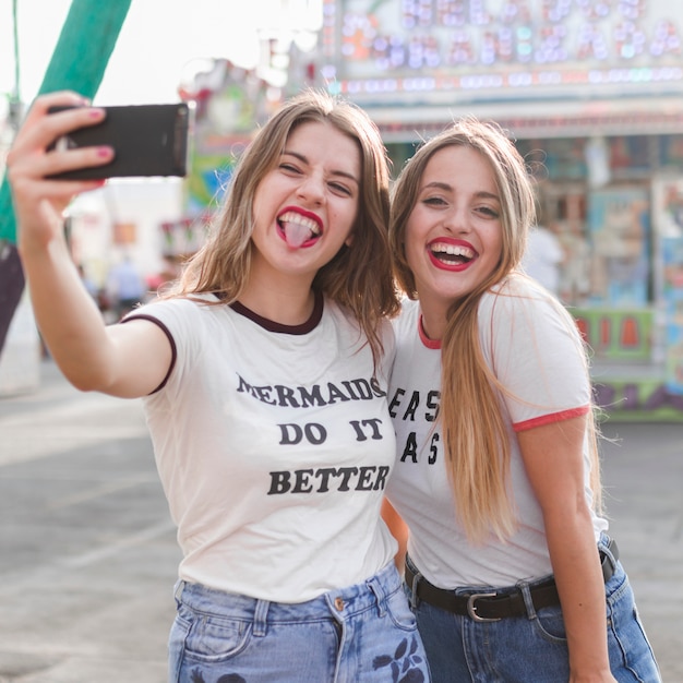 Free photo happy girls having fun in the amusement park