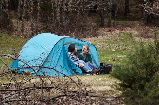 Happy girls resting in the tent