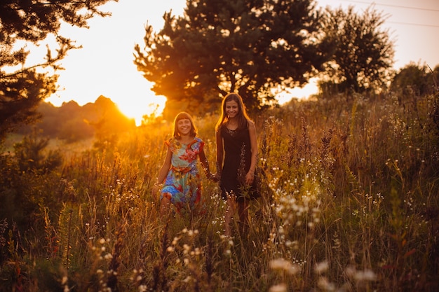 Happy girls walk on the field 