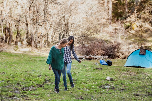 Happy girls walking and leaving the tent