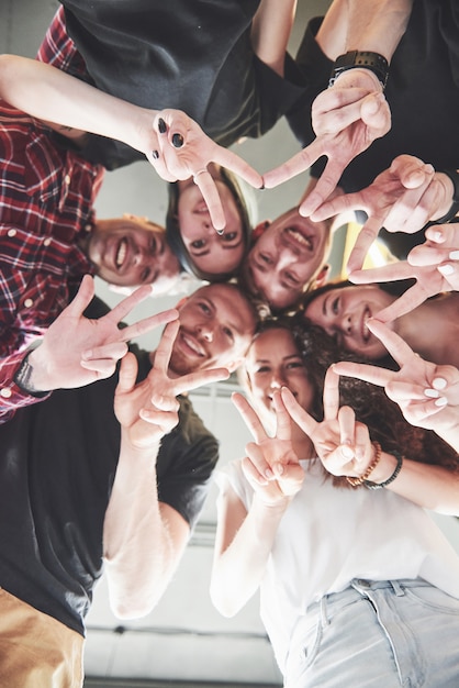 Free Photo happy group of friends with their hands together in the middle