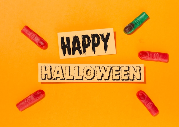 Free Photo happy halloween inscription with artificial fingers