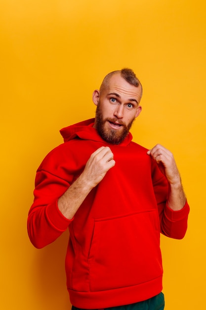 Free Photo happy handsome brutal bearder man wearing warm red winter trendy fleece hoodie