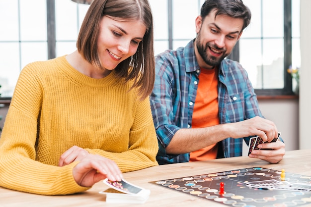 Happy husband and wife playing the business card game