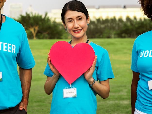 Free Photo happy japanese volunteer with a heart