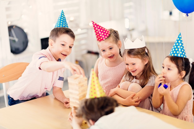 Happy kids playing game at table