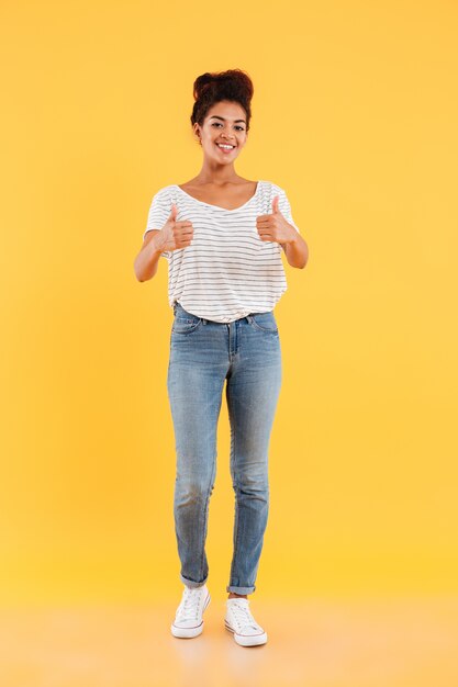 Happy lady with curly hair showing thumbs up isolated