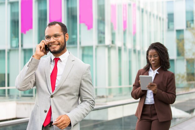 Happy Latin businessman talking on cellphone