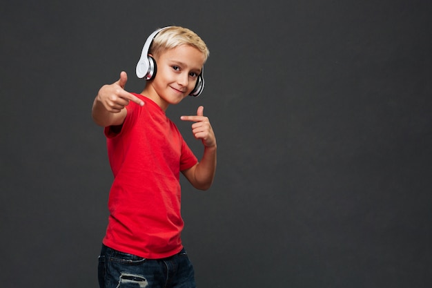 Free Photo happy little boy child listening music with headphones.